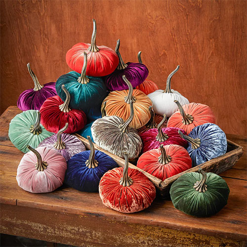 Basket of velvet pumpkins in various colors.