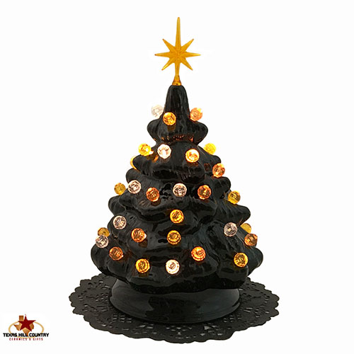 Black Halloween themed ceramic christmas tree with gold and orange lights.