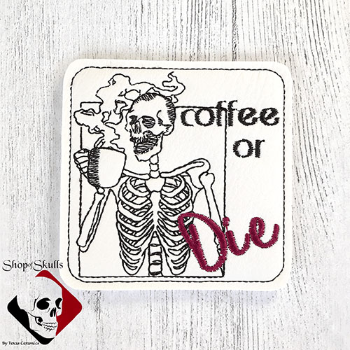 Coaster with embroidered skeleton drinking coffee and the words coffee or die.