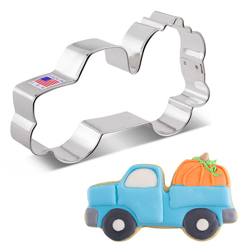 Metal cookie cutter in shape of truck carrying pumpkin with Made in USA sticker.