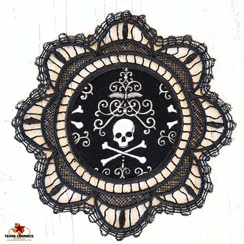 Black antique doily with skull and crown pattern.