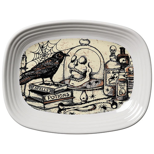 White serving platter with antique evil laboratory scene painted on its face.