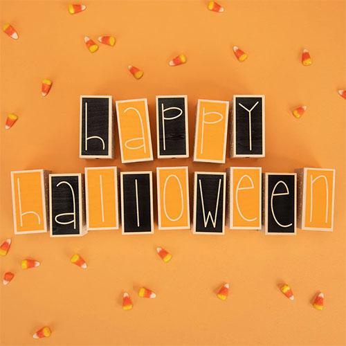 Black and orange wooden blocks spelling the words: Happy Halloween.