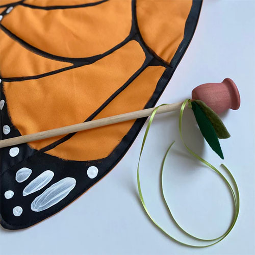 Wooden rose wand with orange butterfly wings costume.