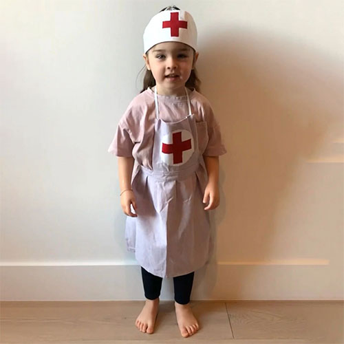 Little girl wearing nurse costume.