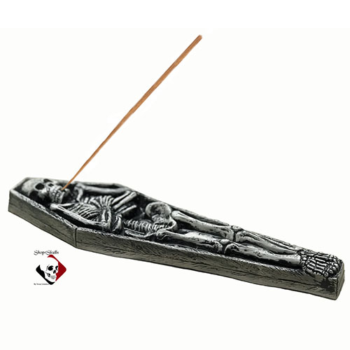 Black skeleton in coffin incense holder.