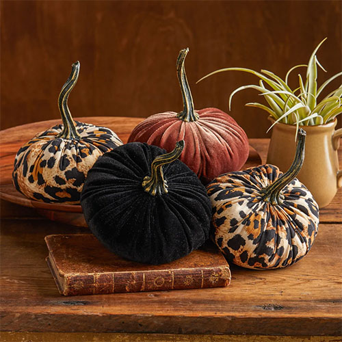 Set of four velvet pumpkins in orange, black and leopard prints.