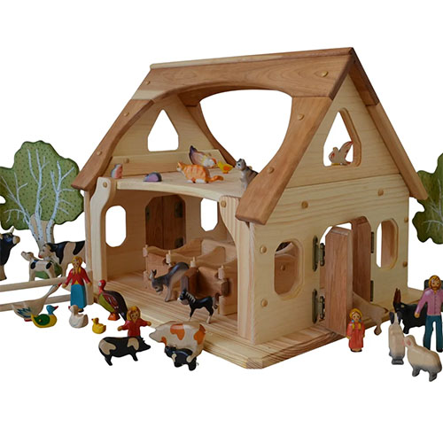 Farm play set with toy wooden animals, people and trees.