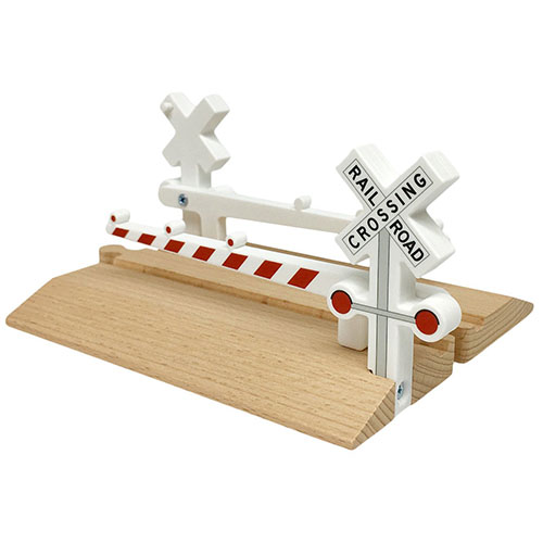 Toy wooden railway crossing with plastic barriers.