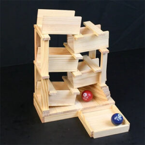 Contraption for rolling balls built from toy wooden planks.