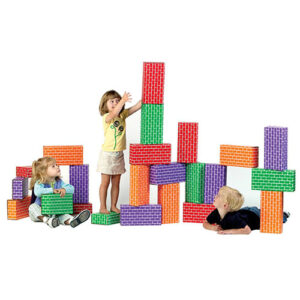 Children playing and building with giant multicolored cardboard building blocks with brick pattern.