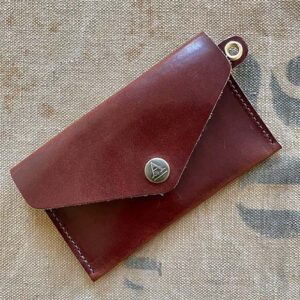 Brown leather envelope snap wallet.