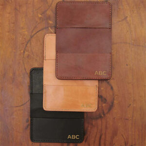 Set of leather card wallets in black, light brown and dark brown.