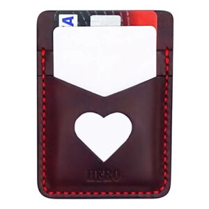 Brown leather card case with heart shaped cutout by Disc Studio.
