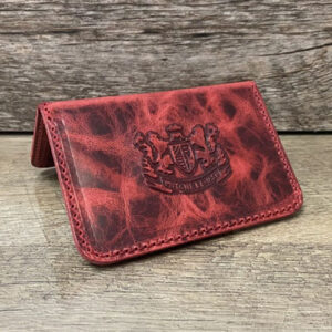 Card wallet in various shades of red embossed with Mitchell Leather seal.