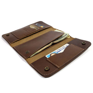 Brown leather clutch wallet with snap closures by Red Clouds Collective.