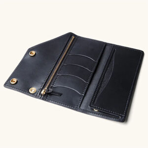 Black leather workman wallet by Tanner Goods with 4 card and 2 cash slots, 1 zipper pocket and snap closures.