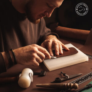 Man crafting leather wallet made in USA.