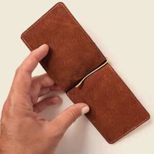 Brown leather money clip folded open.