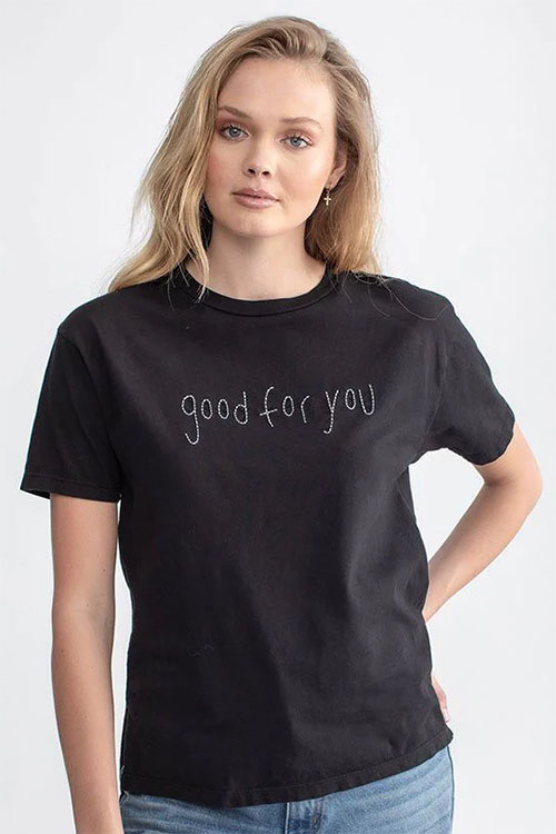 Young woman wearing black t-shirt with 'good for you' written across the chest.