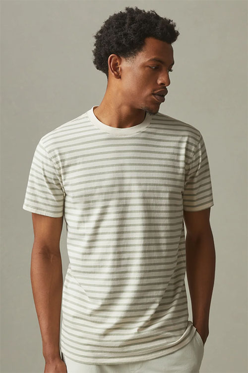 Man wearing white t-shirt with blue stripes.