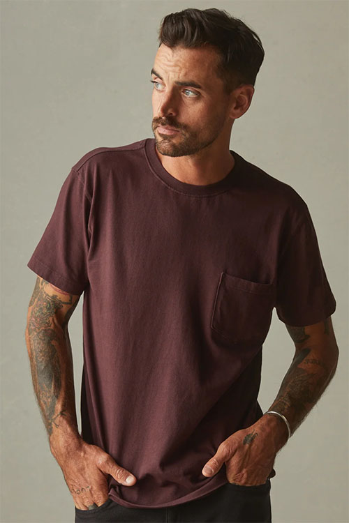 Man wearing red-brown t-shirt with front pocket.
