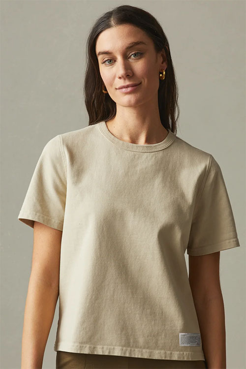 Woman wearing beige t-shirt.