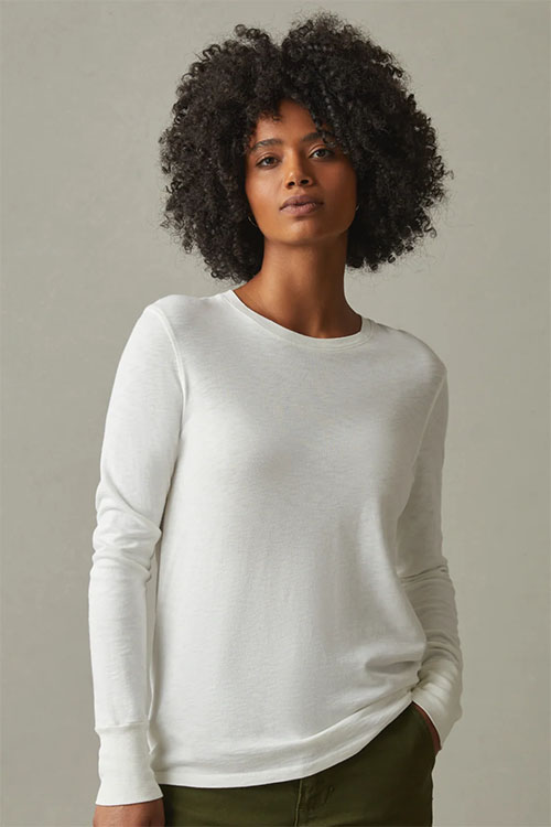 Woman wearing long sleeve white t-shirt.