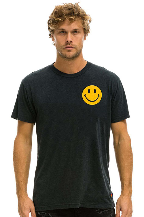 Man wearing black t-shirt with yellow smiley face print.
