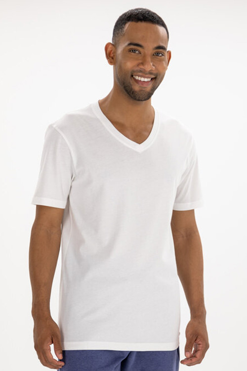 Smiling man wearing white v-neck t-shirt.