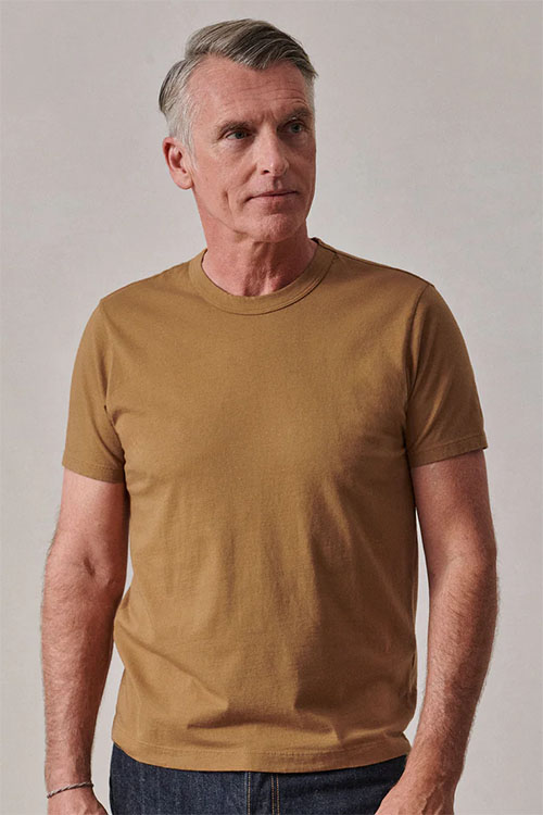 Man wearing light brown t shirt.