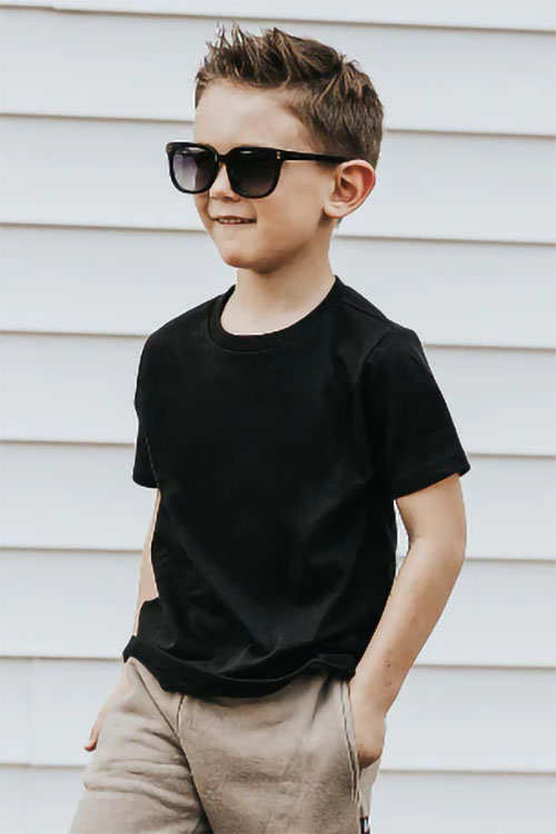 Boy wearing black short sleeve t-shirt.