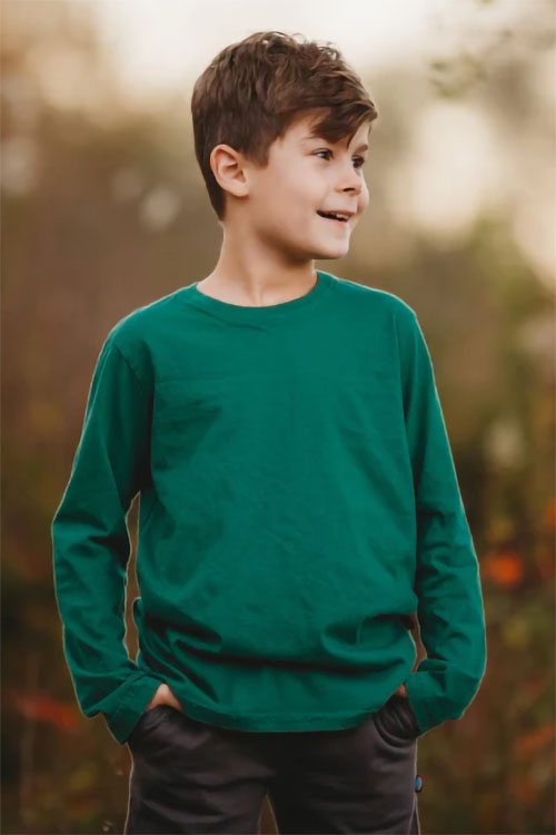 Boy wearing dark green long sleeve t-shirt.