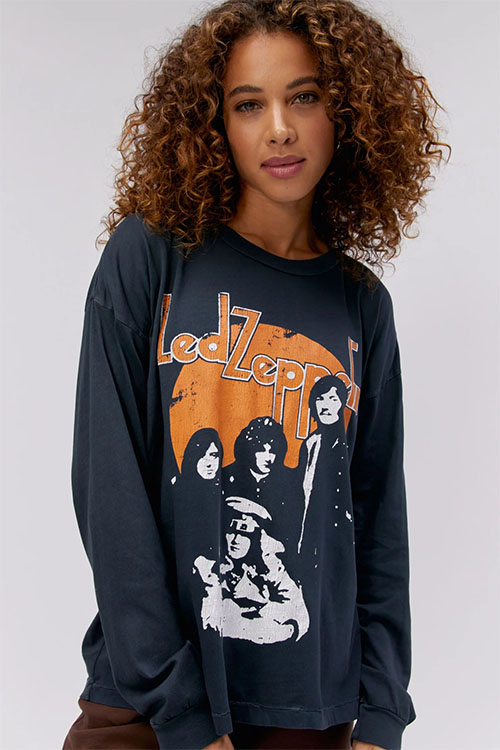 Girl wearing Led Zeppelin themed oversized black t-shirt with long sleeves.