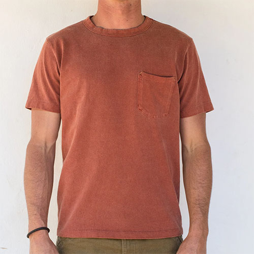 Man wearing rust colored crew neck t-shirt with front pocket.