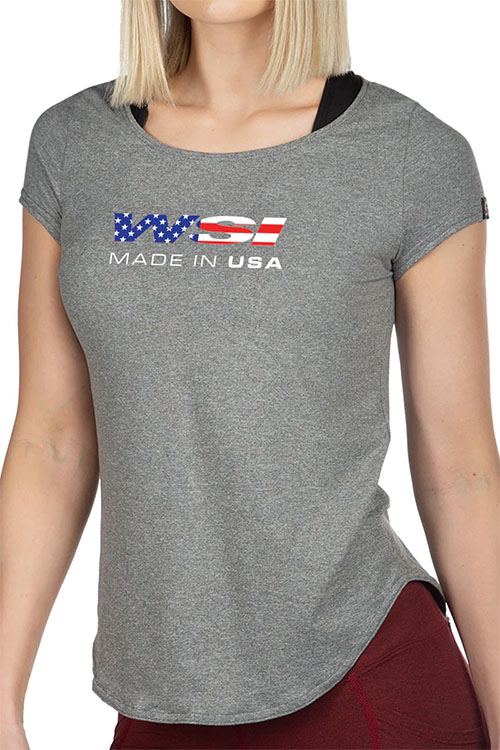 Woman wearing grey t-shirt with American flag and made in USA on the chest.