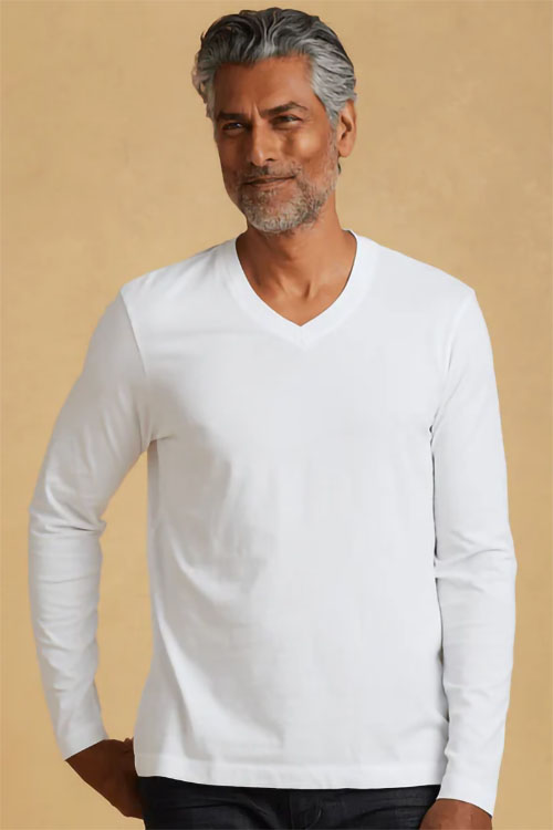 Man wearing white, long sleeve, v-neck t-shirt.