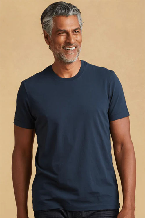 Man wearing navy, crew-neck t-shirt.