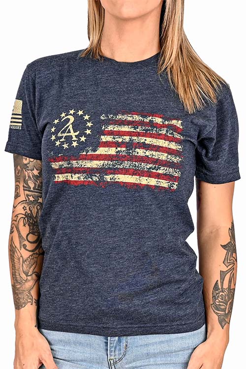 Woman wearing dark blue t-shirt with old American flag on the chest.
