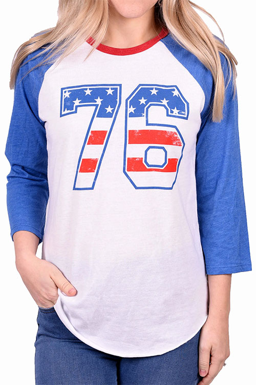 Woman wearing t-shirt with long blue sleeves and the number 76 on the chest in colors of the American flag.