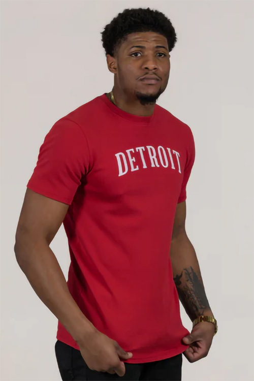 Man wearing red t-shirt with the word 'Detroit' across the chest.