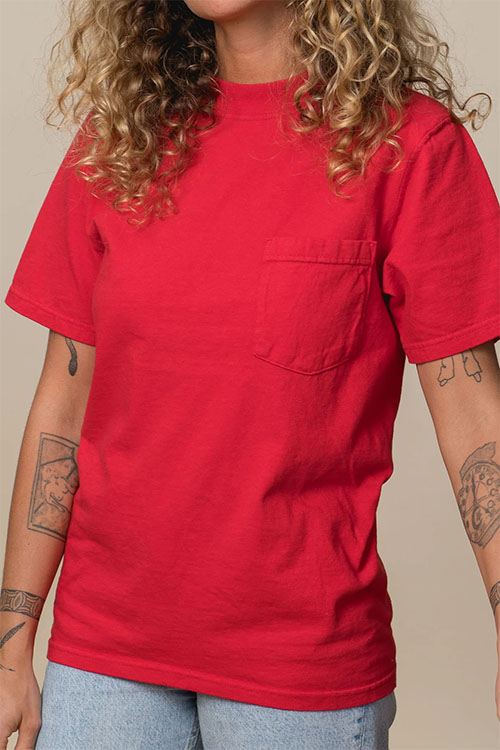Woman wearing red crew-neck t-shirt with front pocket.