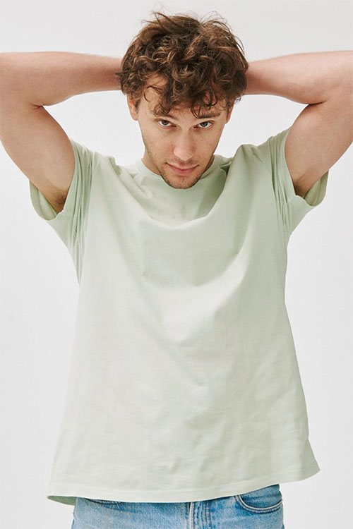 Young man wearing light green crew-neck t-shirt.