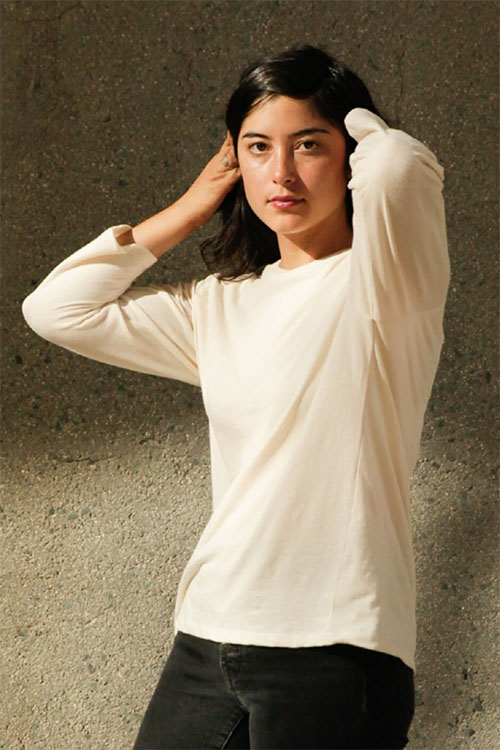 Woman wearing white long sleeve t-shirt.