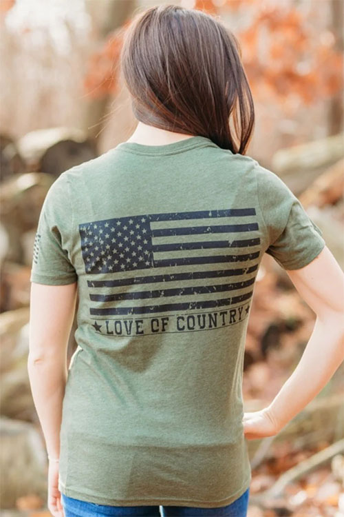 Woman wearing army green t-shirt with American flag on the back.
