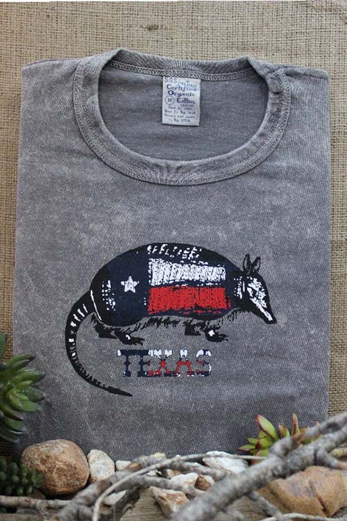 Grey t-shirt with armadillo on the chest colored in a Texas flag pattern.