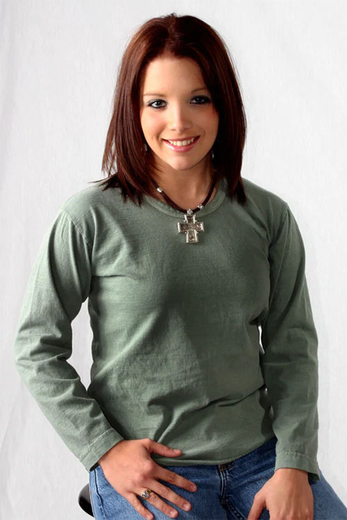 Woman wearing green long sleeve t-shirt.