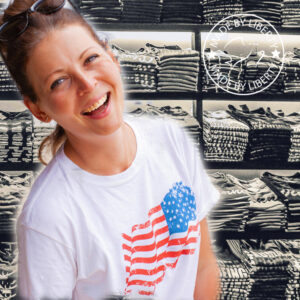 Smiling woman wearing t-shirt with American flag on the chest.