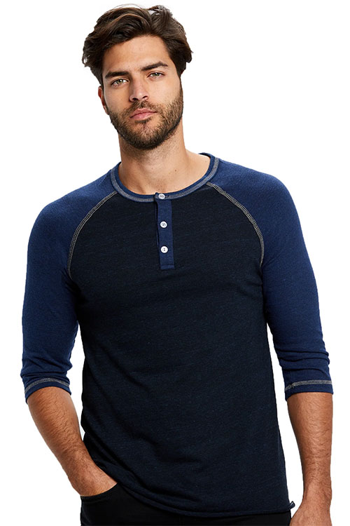 Man wearing blue t-shirt with long sleeves and button-up collar.