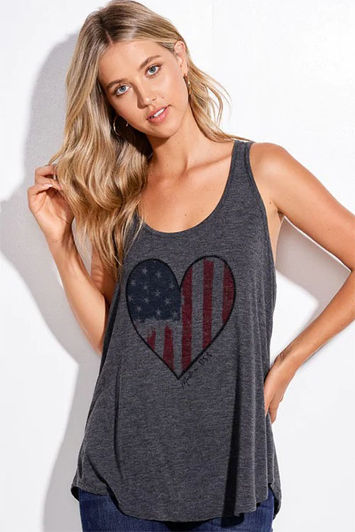 Young woman wearing dark grey tank top with heart-shaped American flag printed on the chest.